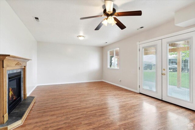 3035 N 2575 W, Farr West, UT 84404 - unfurnished living room with baseboards, french doors, visible vents, and wood finished floors