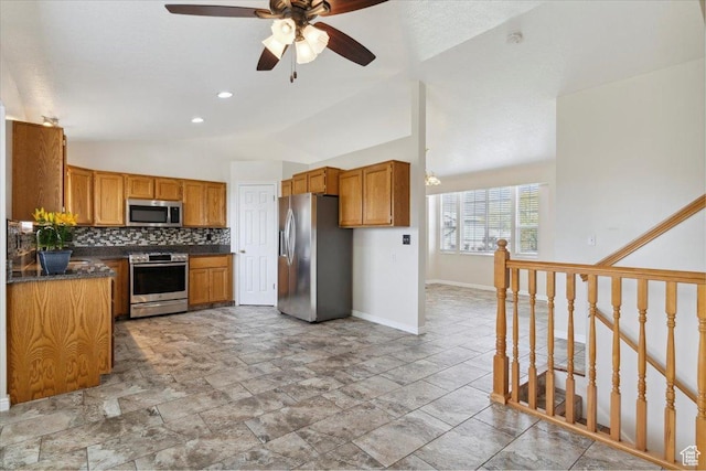 3035 N 2575 W, Farr West, UT 84404 - kitchen with dark countertops, stainless steel appliances, baseboards, ceiling fan, and vaulted ceiling