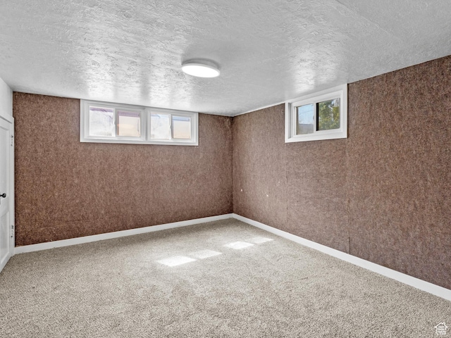 1362 Marilyn Dr, Ogden, UT 84403 - basement featuring plenty of natural light, a textured ceiling, carpet flooring, and baseboards