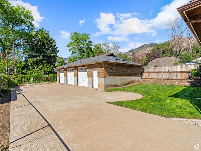 1362 Marilyn Dr, Ogden, UT 84403 - view of side of property with a garage, brick siding, and a mountain view