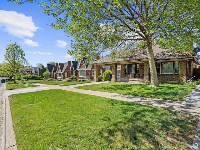 1362 Marilyn Dr, Ogden, UT 84403 - view of front of property with a front lawn, brick siding, covered porch, driveway, and a carport
