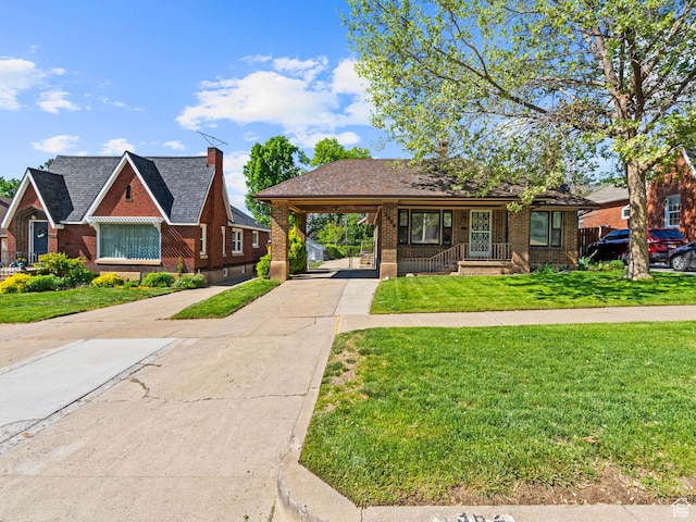 1362 Marilyn Dr, Ogden, UT 84403 - view of front of home with concrete driveway, an attached carport, brick siding, and a front yard