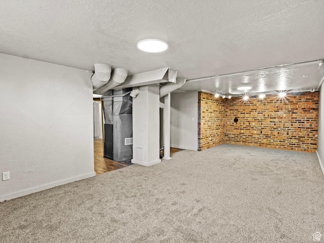 1362 Marilyn Dr, Ogden, UT 84403 - finished basement with carpet flooring, brick wall, a textured ceiling, and baseboards