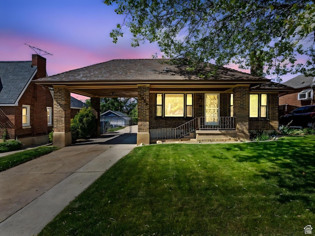 1362 Marilyn Dr, Ogden, UT 84403 - view of front facade featuring concrete driveway, a carport, brick siding, a front lawn, and covered porch