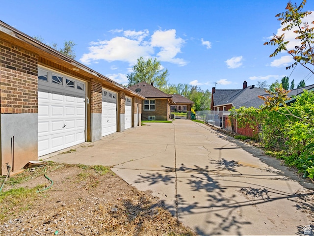 1362 Marilyn Dr, Ogden, UT 84403 - exterior space with brick siding, fence, concrete driveway, and a residential view