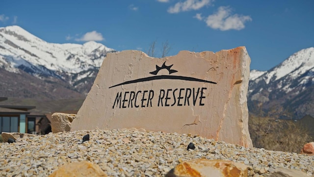 community sign with a mountain view