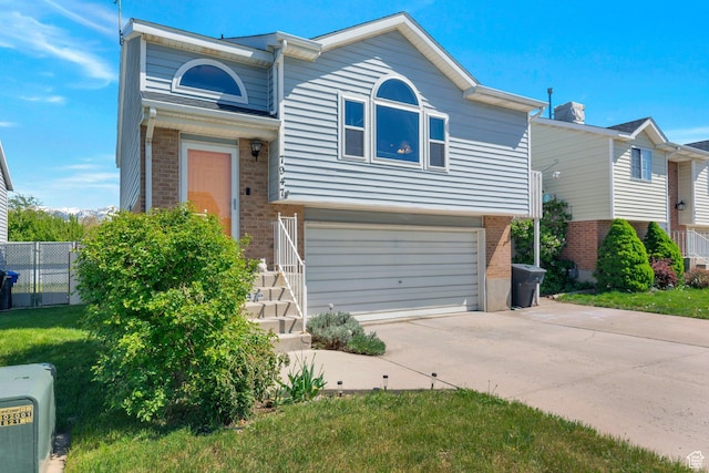 7947 S Linton Dr W, West Jordan, UT 84088 - view of front of home featuring driveway, brick siding, an attached garage, and fence