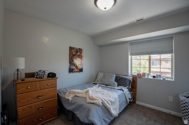 bedroom featuring visible vents, baseboards, and carpet floors