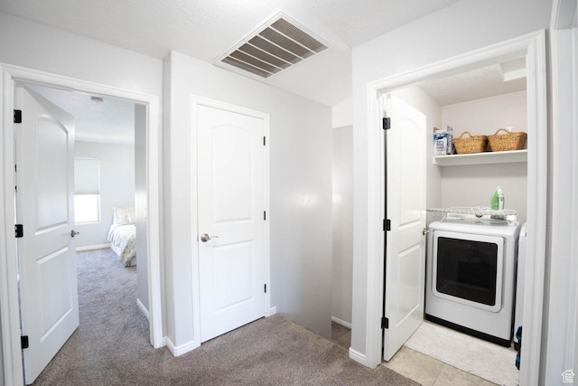 washroom with washer / dryer, laundry area, visible vents, and light colored carpet