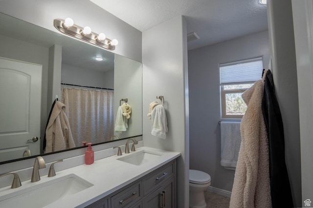 full bathroom featuring a sink, double vanity, toilet, and visible vents