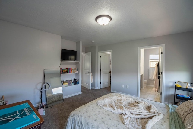 carpeted bedroom with baseboards, connected bathroom, and a textured ceiling