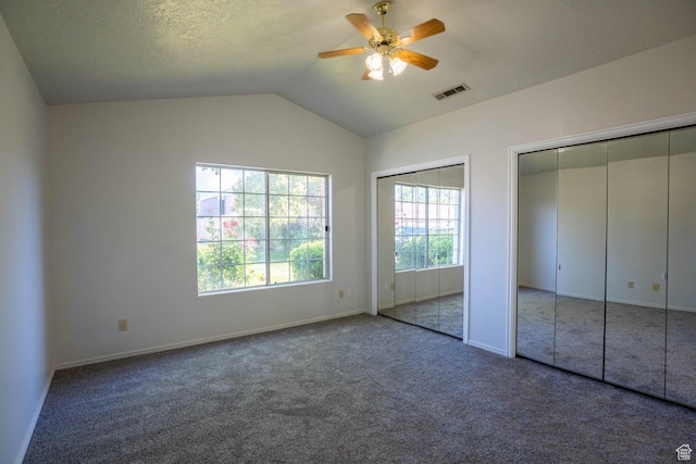 1090 E 700 S Unit 16, St George, UT 84790 - unfurnished bedroom featuring lofted ceiling, baseboards, carpet flooring, visible vents, and two closets