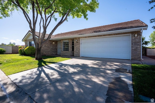 1090 E 700 S Unit 16, St George, UT 84790 - single story home with concrete driveway, brick siding, a garage, and fence