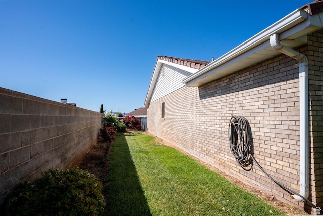 1090 E 700 S Unit 16, St George, UT 84790 - view of side of home with brick siding, fence, and a lawn