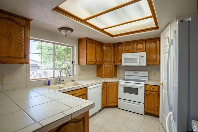 1090 E 700 S Unit 16, St George, UT 84790 - kitchen with tile counters, white appliances, brown cabinets, and a sink