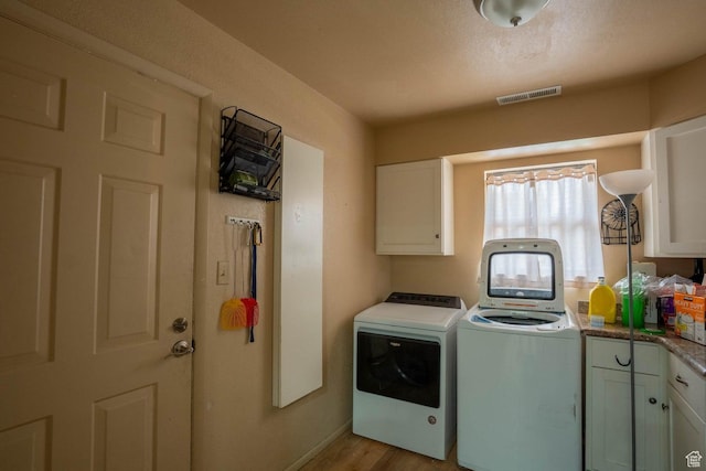 944 Gardenia Cir, St George, UT 84790 - laundry room with light wood finished floors, cabinet space, washing machine and clothes dryer, visible vents, and baseboards