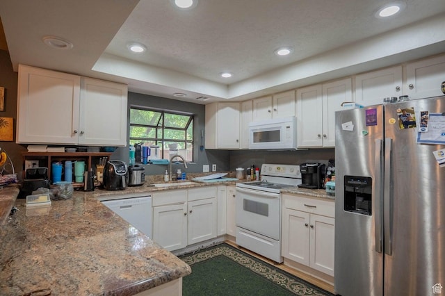 944 Gardenia Cir, St George, UT 84790 - kitchen featuring a tray ceiling, white appliances, a sink, and recessed lighting