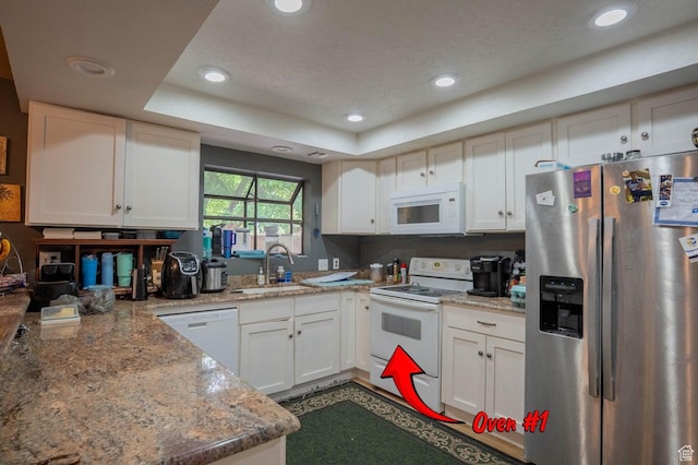 944 Gardenia Cir, St George, UT 84790 - kitchen with a tray ceiling, recessed lighting, a sink, and white appliances