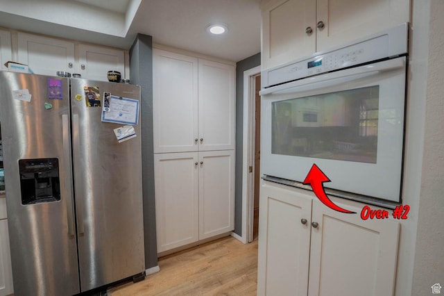 944 Gardenia Cir, St George, UT 84790 - kitchen with white cabinetry, oven, light wood-style flooring, and stainless steel refrigerator with ice dispenser