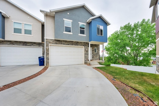94 S Walker Ln, North Salt Lake, UT 84054 - view of front facade featuring stone siding, a garage, driveway, and stucco siding