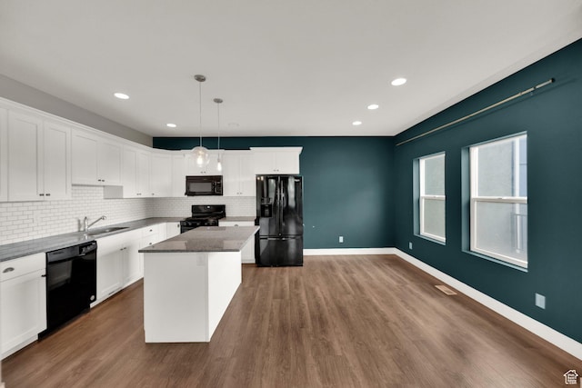 94 S Walker Ln, North Salt Lake, UT 84054 - kitchen featuring black appliances, tasteful backsplash, a center island, white cabinets, and dark wood-style flooring
