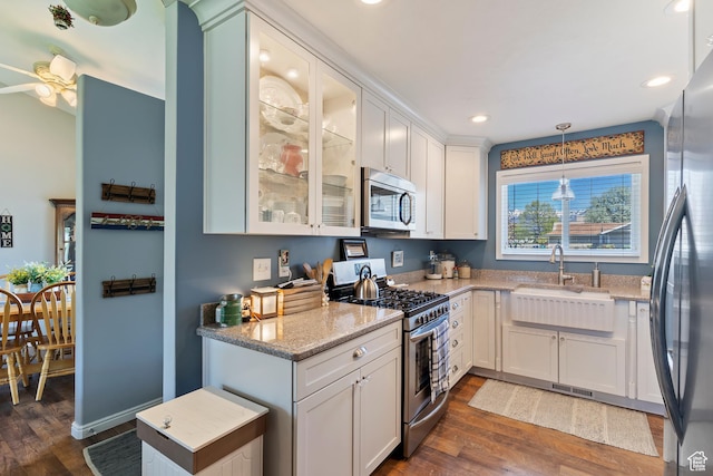 kitchen with white cabinetry, appliances with stainless steel finishes, dark wood-type flooring, and a sink