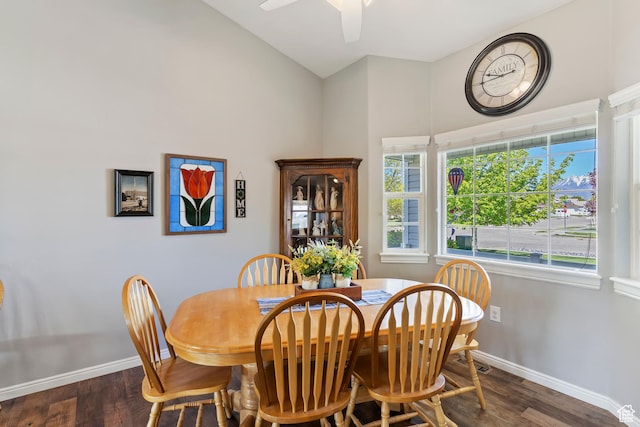 dining room featuring wood finished floors, baseboards, a ceiling fan, and high vaulted ceiling