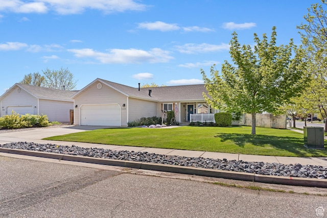single story home featuring concrete driveway, a front yard, and an attached garage
