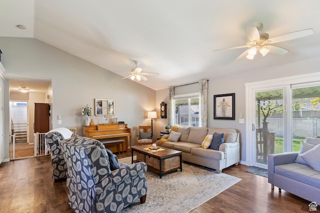 living area featuring a ceiling fan, lofted ceiling, and dark wood finished floors