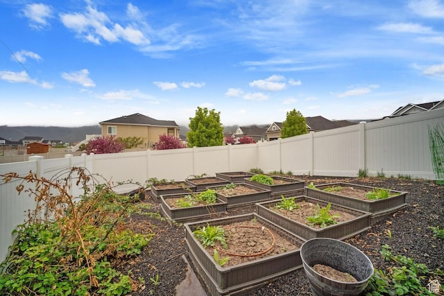 view of yard with a residential view, a garden, and fence
