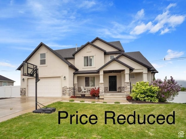 125 E Christley Ln, Elk Ridge, UT 84651 - view of front facade with stucco siding, covered porch, an attached garage, and stone siding