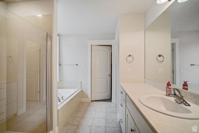 bathroom with vanity, a garden tub, and tile patterned flooring