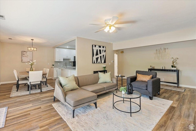 2568 S Elizabeth St Unit 5, Salt Lake City, UT 84106 - living area featuring baseboards, a ceiling fan, visible vents, and light wood-style floors