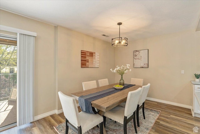 2568 S Elizabeth St Unit 5, Salt Lake City, UT 84106 - dining room with a chandelier, baseboards, and wood finished floors