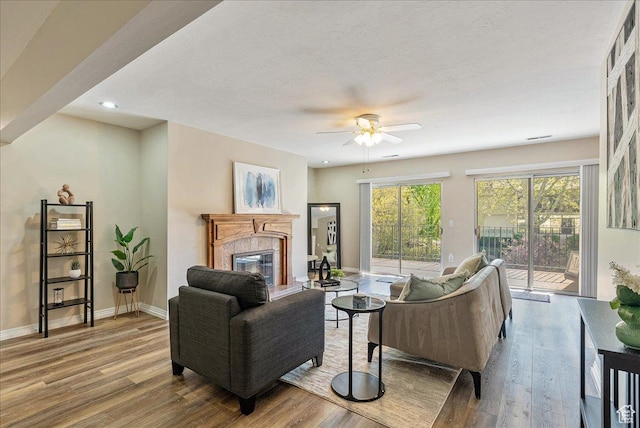 2568 S Elizabeth St Unit 5, Salt Lake City, UT 84106 - living room with a fireplace, baseboards, a ceiling fan, and wood finished floors