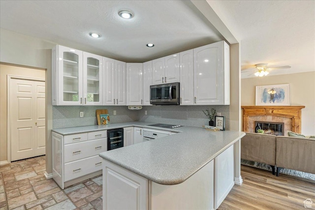 2568 S Elizabeth St Unit 5, Salt Lake City, UT 84106 - kitchen with black electric stovetop, white cabinets, stainless steel microwave, and glass insert cabinets