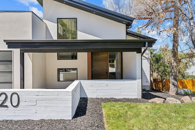 3520 S Westwood Dr E, Millcreek, UT 84109 - doorway to property featuring stucco siding, brick siding, and fence