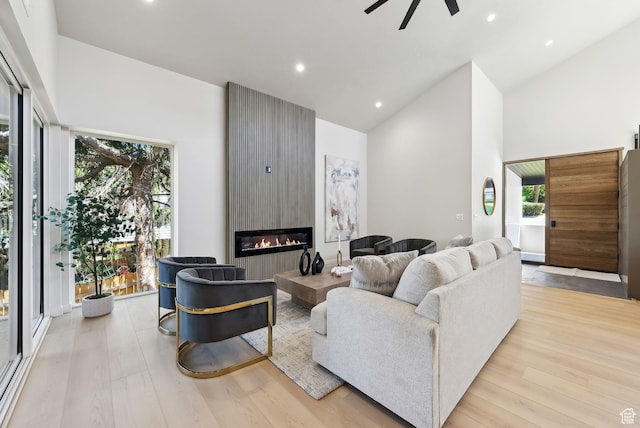 3520 S Westwood Dr E, Millcreek, UT 84109 - living area featuring wood finished floors, high vaulted ceiling, a fireplace, ceiling fan, and recessed lighting