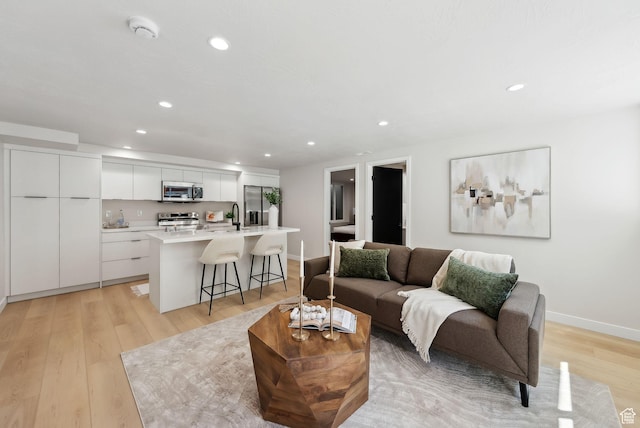 3520 S Westwood Dr E, Millcreek, UT 84109 - living area featuring baseboards, light wood-style floors, and recessed lighting