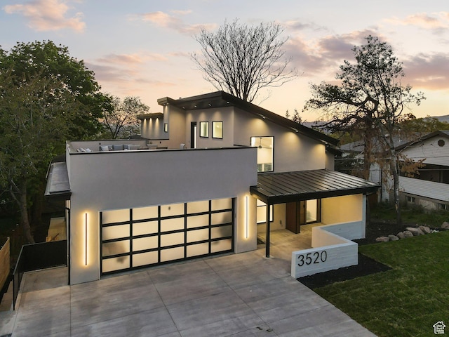 3520 S Westwood Dr E, Millcreek, UT 84109 - contemporary home featuring a standing seam roof, metal roof, a garage, stucco siding, and concrete driveway