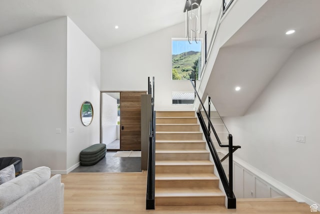 3520 S Westwood Dr E, Millcreek, UT 84109 - stairs with vaulted ceiling, recessed lighting, and wood finished floors