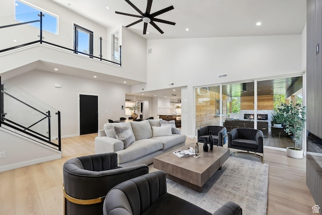 3520 S Westwood Dr E, Millcreek, UT 84109 - living room featuring a ceiling fan, light wood-type flooring, visible vents, and a high ceiling