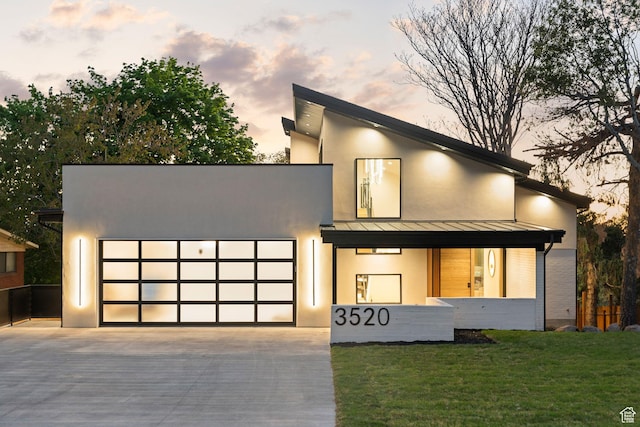 3520 S Westwood Dr E, Millcreek, UT 84109 - modern home with a lawn, a standing seam roof, metal roof, a garage, and concrete driveway