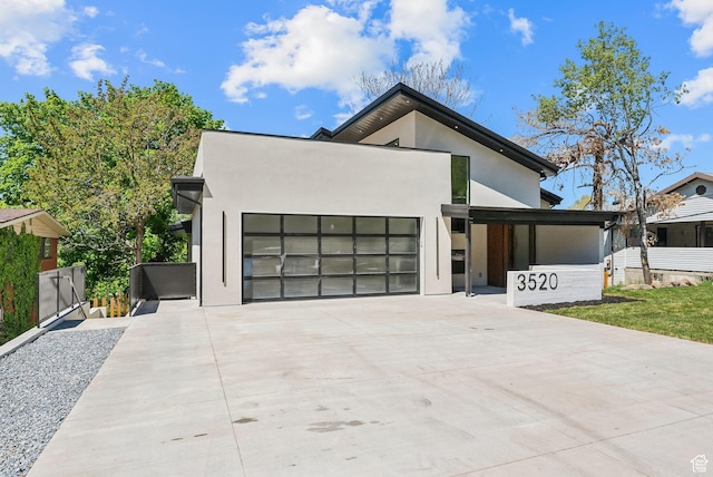 3520 S Westwood Dr E, Millcreek, UT 84109 - contemporary home with concrete driveway, a garage, and stucco siding