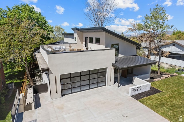 3520 S Westwood Dr E, Millcreek, UT 84109 - contemporary house with an attached garage, concrete driveway, stucco siding, metal roof, and a standing seam roof