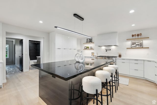 3520 S Westwood Dr E, Millcreek, UT 84109 - kitchen with modern cabinets, open shelves, a kitchen island, white cabinets, and light wood-type flooring