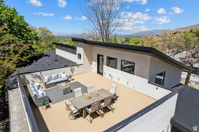 3520 S Westwood Dr E, Millcreek, UT 84109 - back of property featuring stucco siding, an outdoor living space, outdoor dining space, and a deck with mountain view