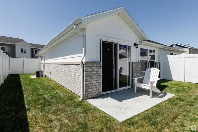 2396 N 150 E, North Logan, UT 84341 - back of house featuring central air condition unit, a patio, a lawn, and a fenced backyard