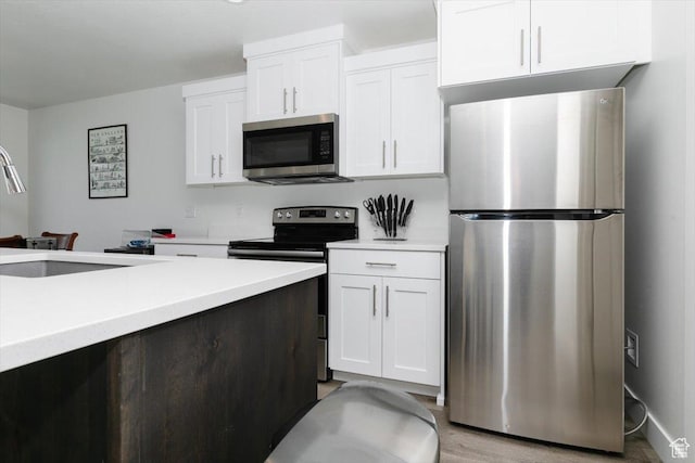 2396 N 150 E, North Logan, UT 84341 - kitchen with white cabinetry, light countertops, appliances with stainless steel finishes, and a sink