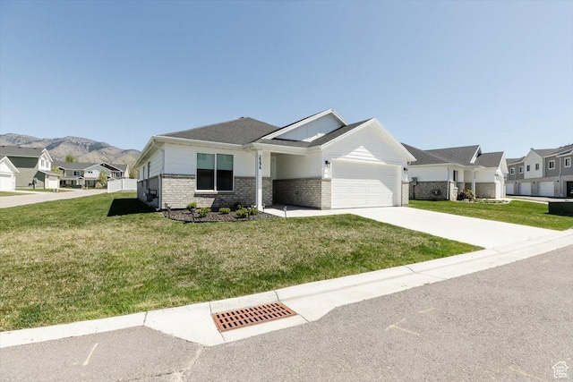 2396 N 150 E, North Logan, UT 84341 - ranch-style home with concrete driveway, a front yard, brick siding, and a garage
